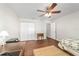 Bedroom featuring wood floors, a ceiling fan, and ample natural light at 2049 Se 37Th Court Cir, Ocala, FL 34471