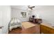 Bright bedroom with wood floors, a window with a view, and desk area at 2049 Se 37Th Court Cir, Ocala, FL 34471