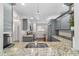 Stylish kitchen featuring gray cabinets, granite counters and modern fixtures at 2049 Se 37Th Court Cir, Ocala, FL 34471