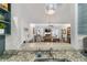 Open-concept kitchen with granite countertops offering view to the living spaces at 2049 Se 37Th Court Cir, Ocala, FL 34471