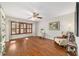 Comfortable living room showcasing plantation shutters, wood floors, decor, and a ceiling fan at 2049 Se 37Th Court Cir, Ocala, FL 34471