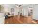 Open living room with wood floors, neutral walls, ample light, and access to other rooms at 2049 Se 37Th Court Cir, Ocala, FL 34471