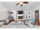 Spacious living room with fireplace, hardwood floors, and large windows for natural light at 2049 Se 37Th Court Cir, Ocala, FL 34471