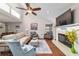Cozy living room with vaulted ceilings, fireplace, and comfortable seating arrangement at 2049 Se 37Th Court Cir, Ocala, FL 34471