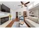 Bright living room featuring a fireplace, hardwood floors, and comfortable seating at 2049 Se 37Th Court Cir, Ocala, FL 34471
