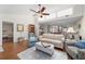 Spacious living room featuring hardwood floors and open floor plan to dining area at 2049 Se 37Th Court Cir, Ocala, FL 34471