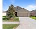 Charming single-story home featuring a well-maintained lawn and attached two-car garage at 224 Nova Dr, Davenport, FL 33837