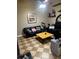 Cozy living room features checkered flooring, comfy seating, and a functional layout for modern living at 5127 Eaglesmere Dr # A02, Orlando, FL 32819
