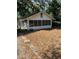 View of exterior showing the front of the home with a yard covered in leaves at 5429 Vanderlin St, Orlando, FL 32810
