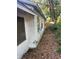 Angled exterior view showing the side of the home and yard at 5429 Vanderlin St, Orlando, FL 32810
