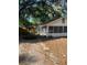 Exterior view of the home with stone walkway leading to the entrance and yard with fallen leaves at 5429 Vanderlin St, Orlando, FL 32810