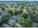 Neighborhood aerial view highlighting a well-maintained community surrounded by mature trees at 3905 Westerham Dr, Clermont, FL 34711
