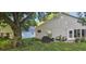 Expansive backyard features a patio with comfortable seating and lush landscaping at 3905 Westerham Dr, Clermont, FL 34711