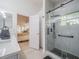 Beautiful bathroom featuring a glass enclosed shower with black hardware, and a view into the main bedroom at 3905 Westerham Dr, Clermont, FL 34711
