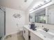 Modern bathroom with double sinks, sleek fixtures, marble style accents, and a glass-enclosed shower at 3905 Westerham Dr, Clermont, FL 34711