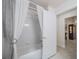 Bathroom featuring a tub with a shower curtain and tiled walls at 3905 Westerham Dr, Clermont, FL 34711