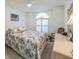 Cozy bedroom featuring tropical decor, a ceiling fan, and shuttered window at 3905 Westerham Dr, Clermont, FL 34711