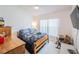 Bedroom featuring a bed, wooden furniture, and a bright window at 3905 Westerham Dr, Clermont, FL 34711