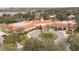 Elegant clubhouse exterior showcasing a circular driveway, mature landscaping, and covered entrance at 3905 Westerham Dr, Clermont, FL 34711