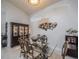 Elegant dining room featuring a glass table, decorative chairs, and stylish wall decor at 3905 Westerham Dr, Clermont, FL 34711