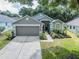 Charming home with a manicured lawn and well-maintained landscaping at 3905 Westerham Dr, Clermont, FL 34711