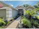 Charming home featuring a fountain, well-manicured landscaping, and a paver walkway at 3905 Westerham Dr, Clermont, FL 34711