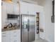 Contemporary kitchen showcasing modern appliances, white cabinetry, and a convenient pantry at 3905 Westerham Dr, Clermont, FL 34711