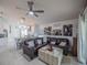 Comfortable living room featuring stylish decor, lots of light, and open access to the kitchen at 3905 Westerham Dr, Clermont, FL 34711