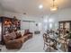 Spacious living room featuring a leather couch, dining table, and large windows at 3905 Westerham Dr, Clermont, FL 34711
