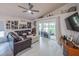 Cozy living room featuring comfortable seating, access to the outdoor patio, and a stylish ceiling fan at 3905 Westerham Dr, Clermont, FL 34711