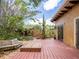 Backyard with wood patio, lush greenery and access to storage shed at 4209 Forrestal Ave, Orlando, FL 32806