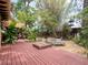 Enjoy the tranquility of a secluded backyard with mature trees and wood patio at 4209 Forrestal Ave, Orlando, FL 32806