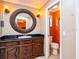 Bathroom with dark wood vanity and marble countertop beside the toilet at 4209 Forrestal Ave, Orlando, FL 32806