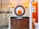 Bathroom features a dark wood vanity with marble countertop and walk-in shower with stone accents at 4209 Forrestal Ave, Orlando, FL 32806
