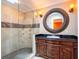 Bathroom with walk-in shower and dark wood vanity with a marble countertop at 4209 Forrestal Ave, Orlando, FL 32806