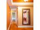 Hallway with wood floors and decorative mirror to help brighten the area at 4209 Forrestal Ave, Orlando, FL 32806