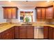 Updated kitchen showcasing custom cabinetry, granite countertops, and stainless steel dishwasher at 4209 Forrestal Ave, Orlando, FL 32806