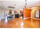 Open-concept living and dining area with hardwood floors, stylish chandelier, and a glimpse of the kitchen at 4209 Forrestal Ave, Orlando, FL 32806