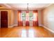 Bright living room with hardwood floors, large windows, and decorative curtains at 4209 Forrestal Ave, Orlando, FL 32806