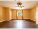 Spacious living room with a ceiling fan, window with curtains, and hardwood floors at 4209 Forrestal Ave, Orlando, FL 32806
