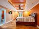This bedroom features a decorative ceiling, an exterior door, and warm color tones at 4209 Forrestal Ave, Orlando, FL 32806