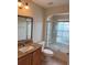 Bathroom featuring vanity with a sink and shower with a glass door at 17430 Se 110Th Ter, Summerfield, FL 34491