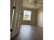 Cozy bedroom features hardwood floors, a vaulted ceiling, and natural light from the window at 17430 Se 110Th Ter, Summerfield, FL 34491