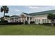 Exterior view of the clubhouse with a well-manicured lawn and landscaping at 17430 Se 110Th Ter, Summerfield, FL 34491