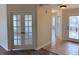 Inviting foyer features tiled flooring, glass paneled front door, and decorative french doors at 17430 Se 110Th Ter, Summerfield, FL 34491