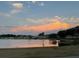 Scenic lake view reflecting the sunset sky with community homes in the background at 17430 Se 110Th Ter, Summerfield, FL 34491