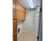 Cozy pantry featuring wood cabinets, wire shelves, and tile flooring at 17430 Se 110Th Ter, Summerfield, FL 34491