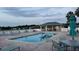 Community pool featuring lounge chairs, patio tables, and a covered area for community members at 17430 Se 110Th Ter, Summerfield, FL 34491