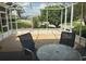 Relaxing sunroom featuring outdoor views and comfortable seating at 17430 Se 110Th Ter, Summerfield, FL 34491