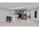 Modern kitchen with stainless steel appliances, a breakfast bar, and light gray cabinetry at 2508 Yale Ave, Sanford, FL 32773